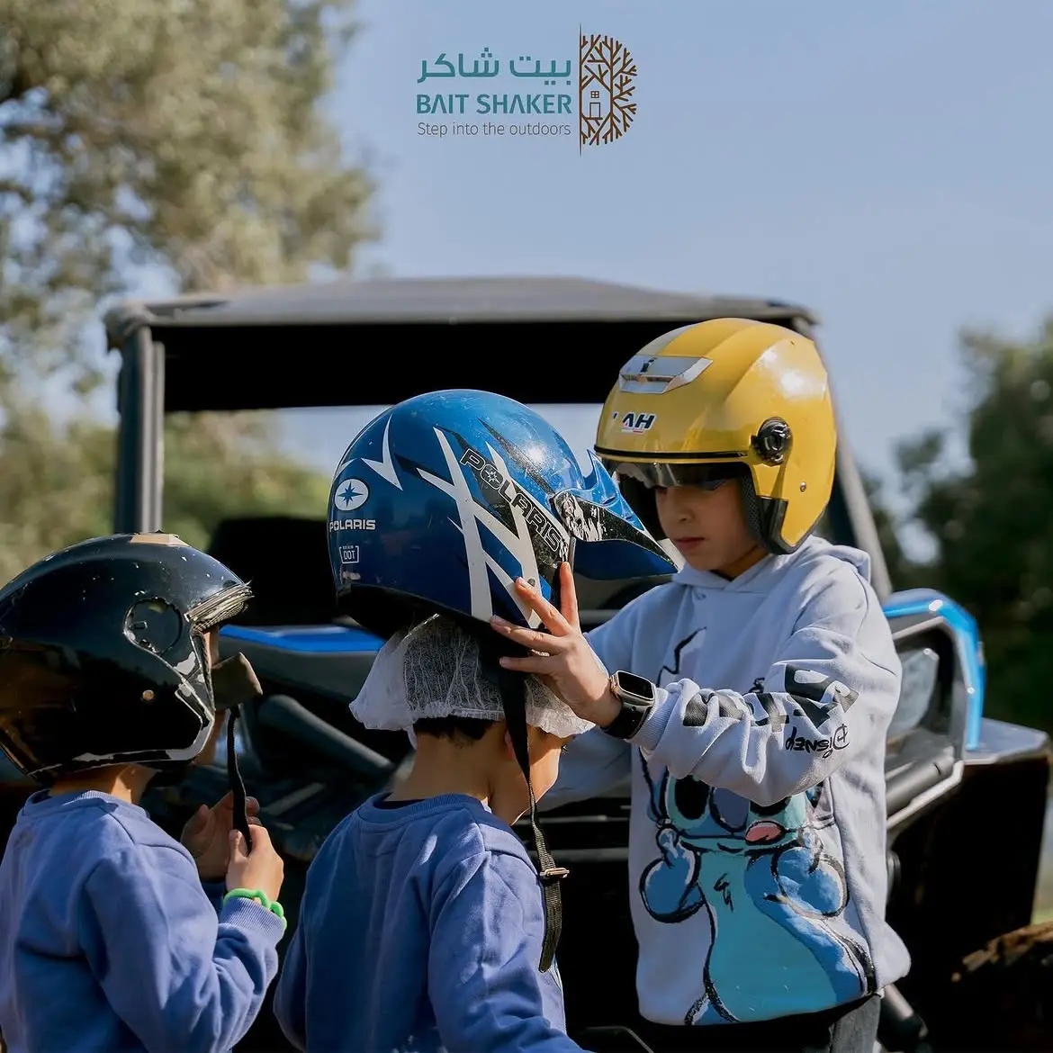 Child in a safety helmet ready for a kids' ATV ride at Bait Shaker, 35 minutes from Amman