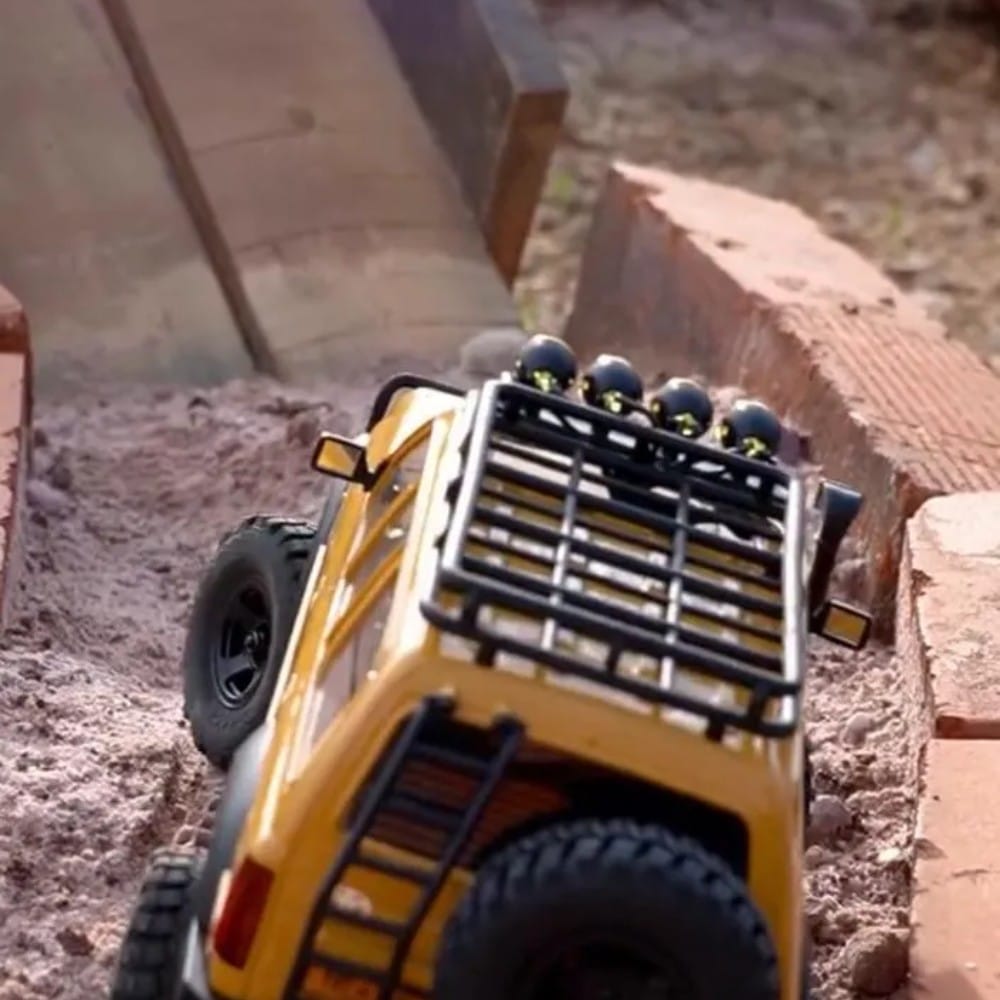 A remote-controlled off-road car climbing rocks at Bait Shaker
