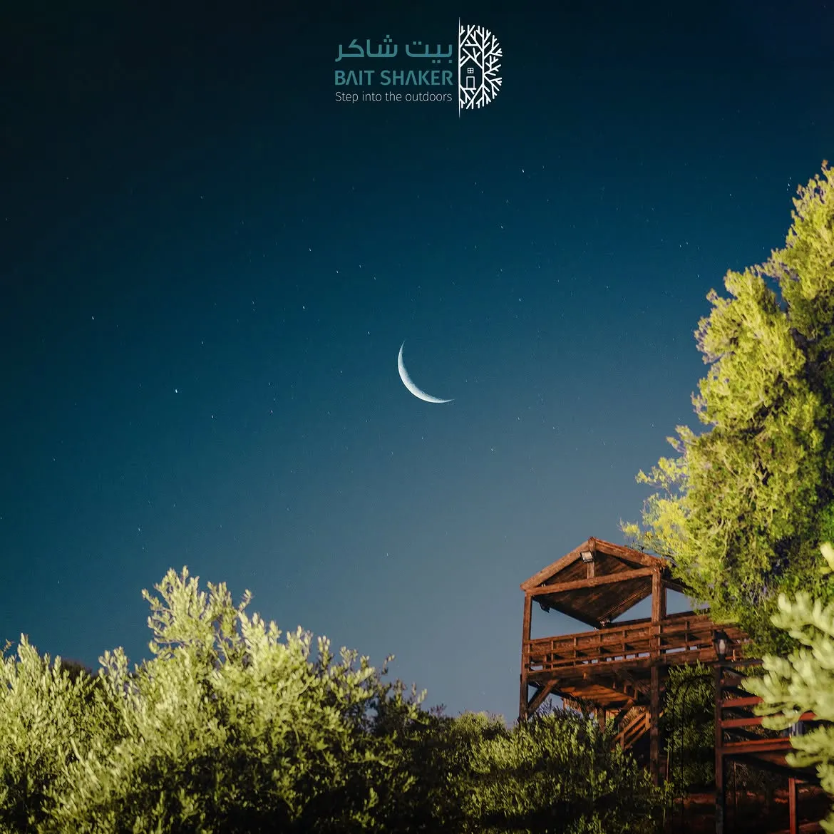 A crescent moon over the tree house at Bait Shaker at night